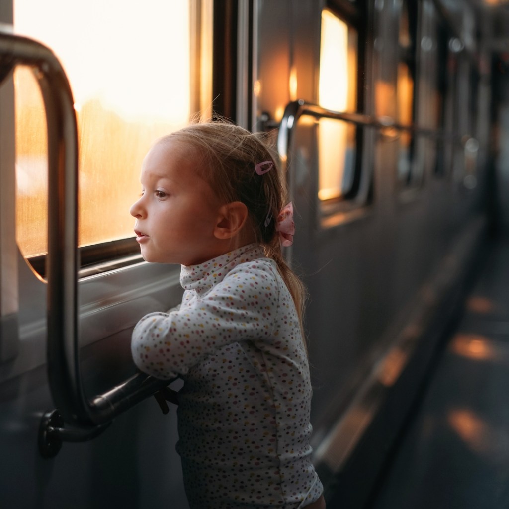 Child looking out the window in public transit