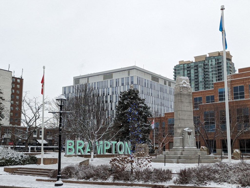 A large sign spelling out "BRAMPTON" in front of Brampton City Hall in Ken Whillans Square.